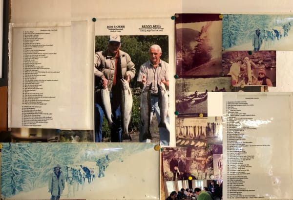 A photograph of a bulletin board featuring various photos of fishing exploits
