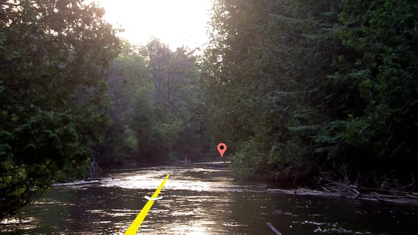 A device GPS UI overlaid on river indicates the direction is just upstream