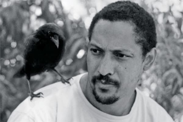The author Percival Everett with a crow perched on his shoulder